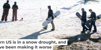 Skiers and snowboarders walk across dry ground to reach a slope at Bear Mountain ski resort on Dec. 21, 2025, in California. Eric Thayer/Los Angeles Times via Getty Images